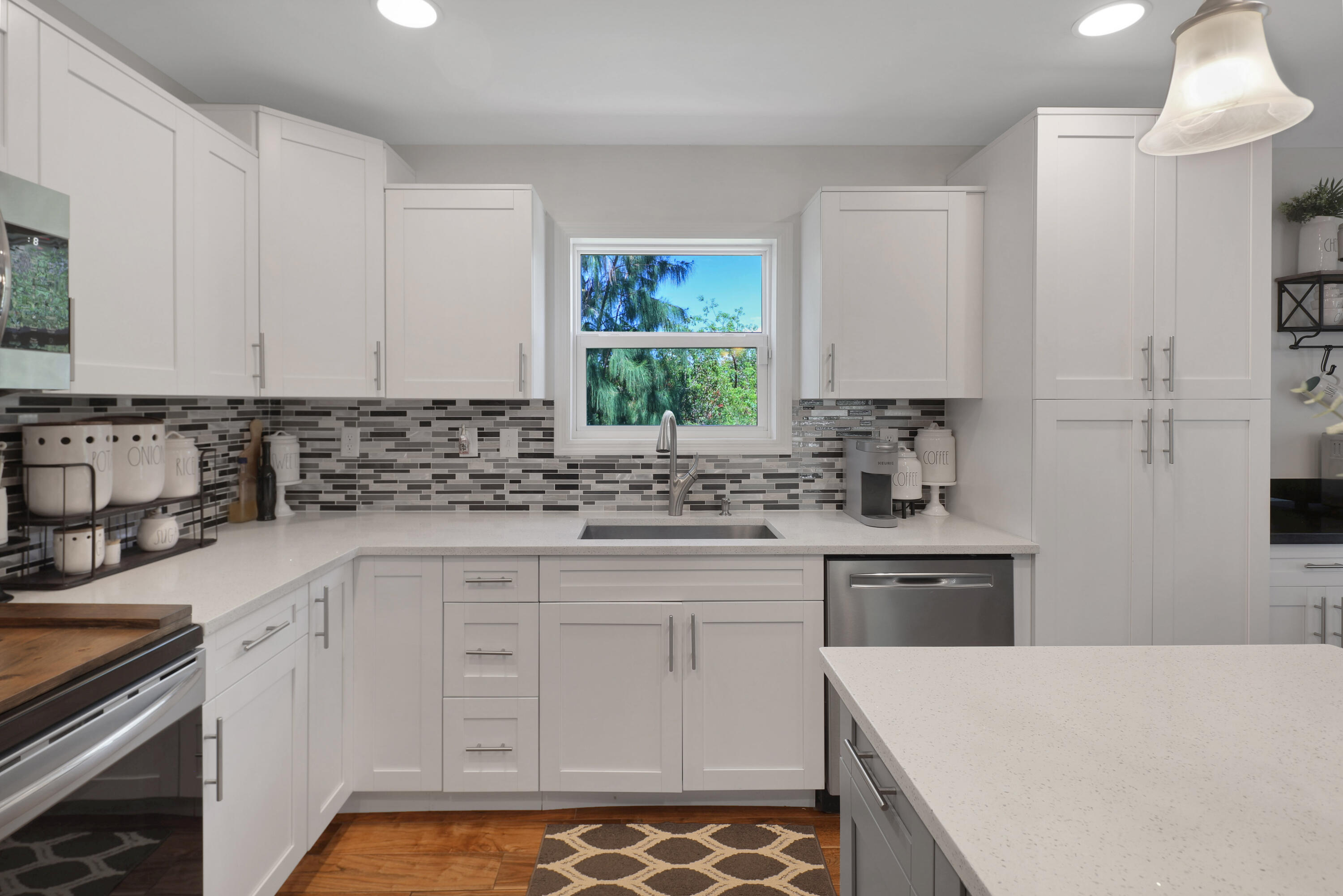 27087 Angel Fish Road Summerland Key, FL 33042 - Photo 7 of 32 a kitchen with white cabinets sink and stove