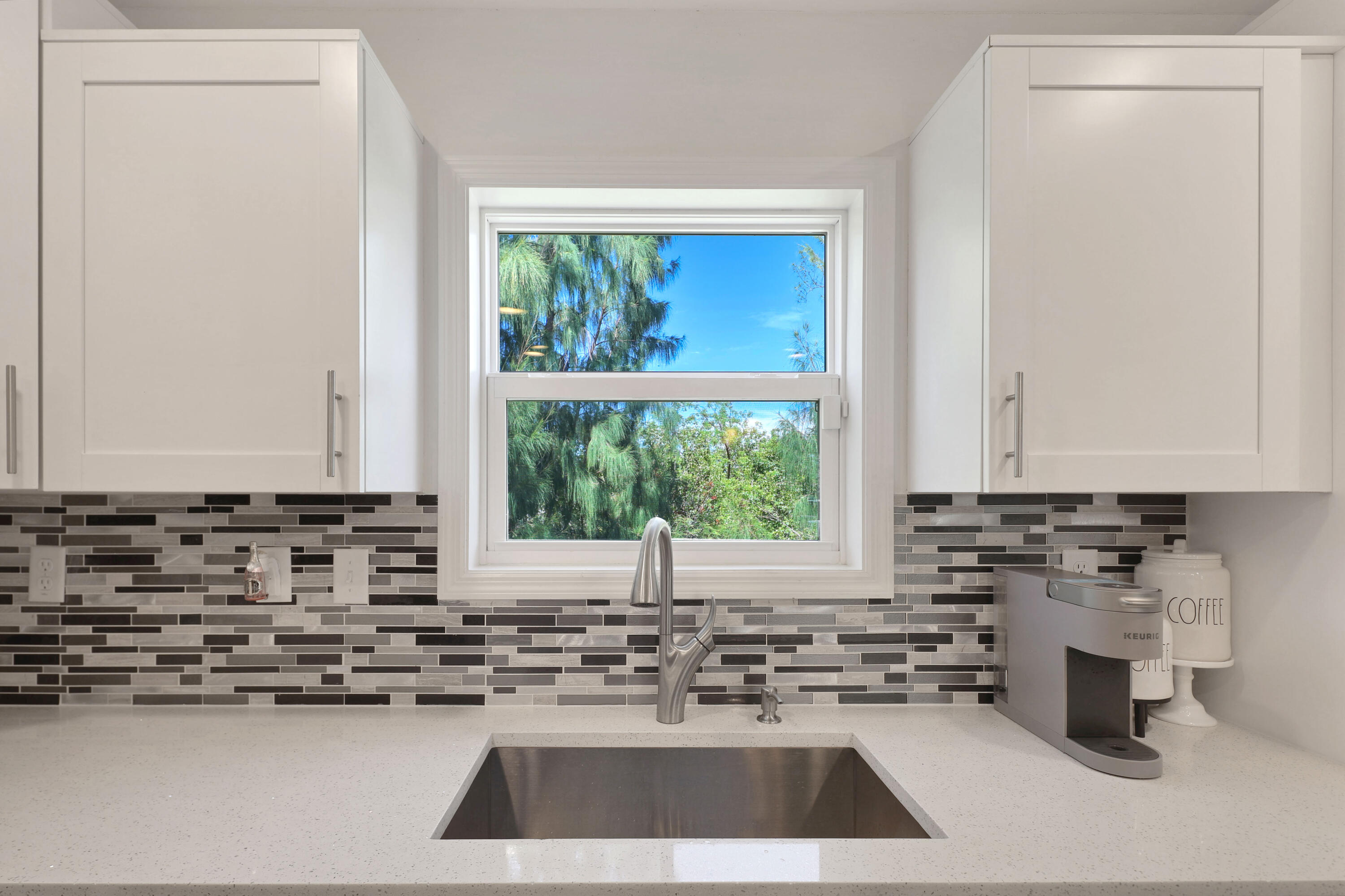 27087 Angel Fish Road Summerland Key, FL 33042 - Photo 8 of 32 a kitchen with a sink a window and cabinets
