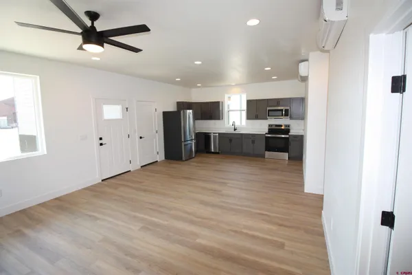 a view of kitchen with stainless steel appliances refrigerator stove microwave and cabinets