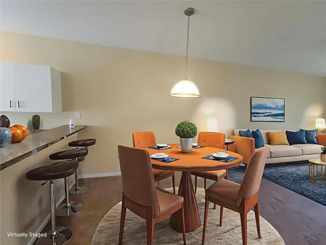 a dining room with furniture and wooden floor