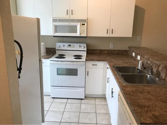 a kitchen with a sink a stove and refrigerator