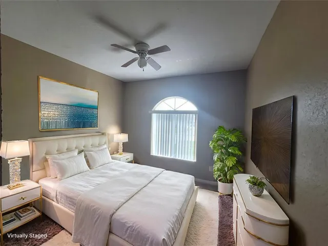 a bed room with a bed window and a flat screen tv