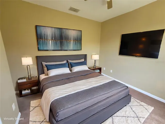 a bedroom with a bed and a flat screen tv