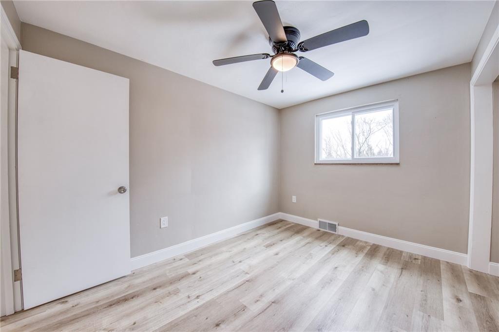 2158 Reis Run Road Pittsburgh, PA 15237 - Photo 23 of 50 an empty room with wooden floor ceiling fan and windows
