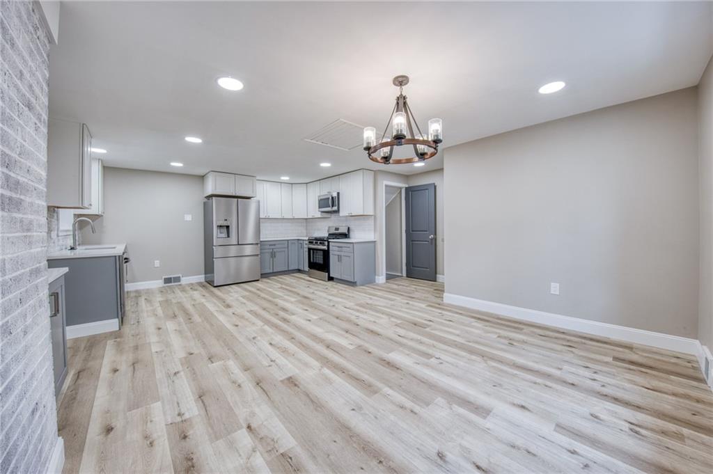 2158 Reis Run Road Pittsburgh, PA 15237 - Photo 33 of 50 a view of empty room with wooden floor and kitchen view
