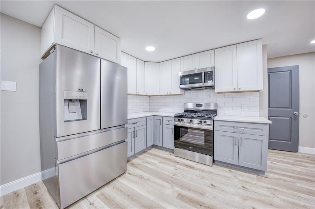 2158 Reis Run Road Pittsburgh, PA 15237 - Photo 38 of 50 a kitchen with stainless steel appliances granite countertop a refrigerator and a stove top oven