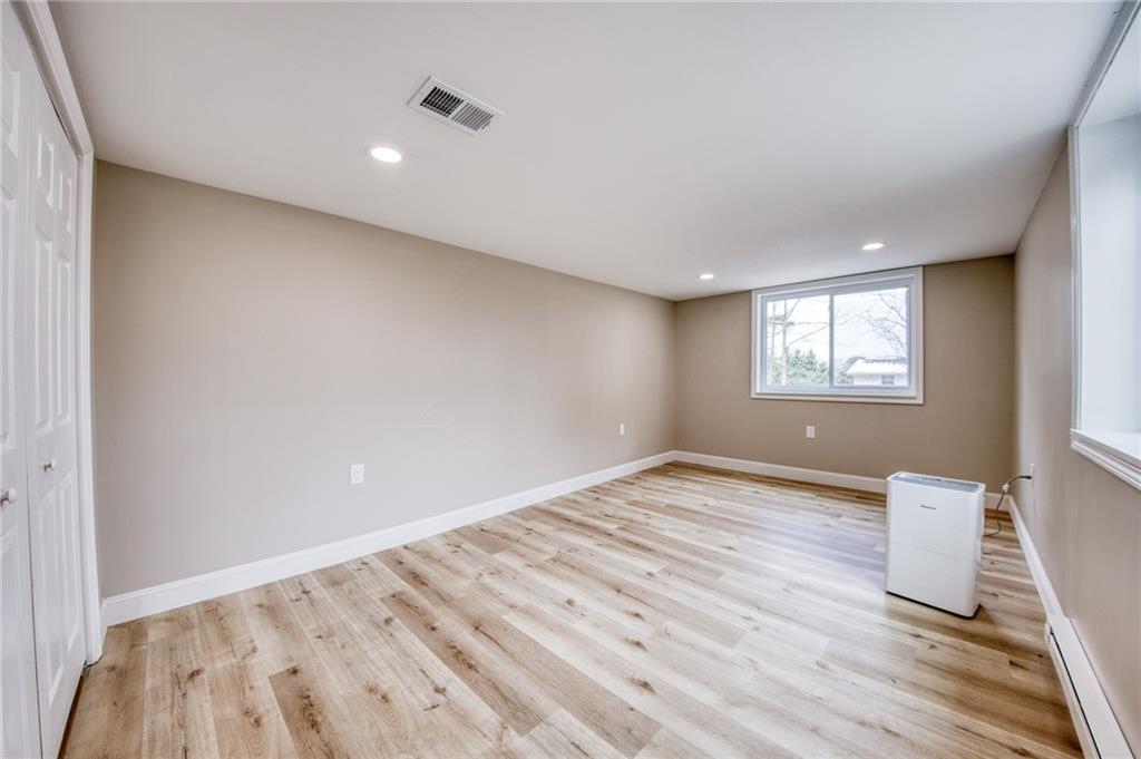 2158 Reis Run Road Pittsburgh, PA 15237 - Photo 48 of 50 a view of an empty room with wooden floor and a window