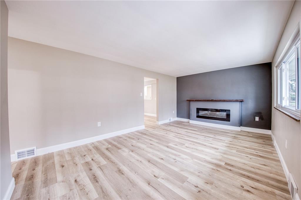 2158 Reis Run Road Pittsburgh, PA 15237 - Photo 8 of 50 a view of empty room with wooden floor and fireplace