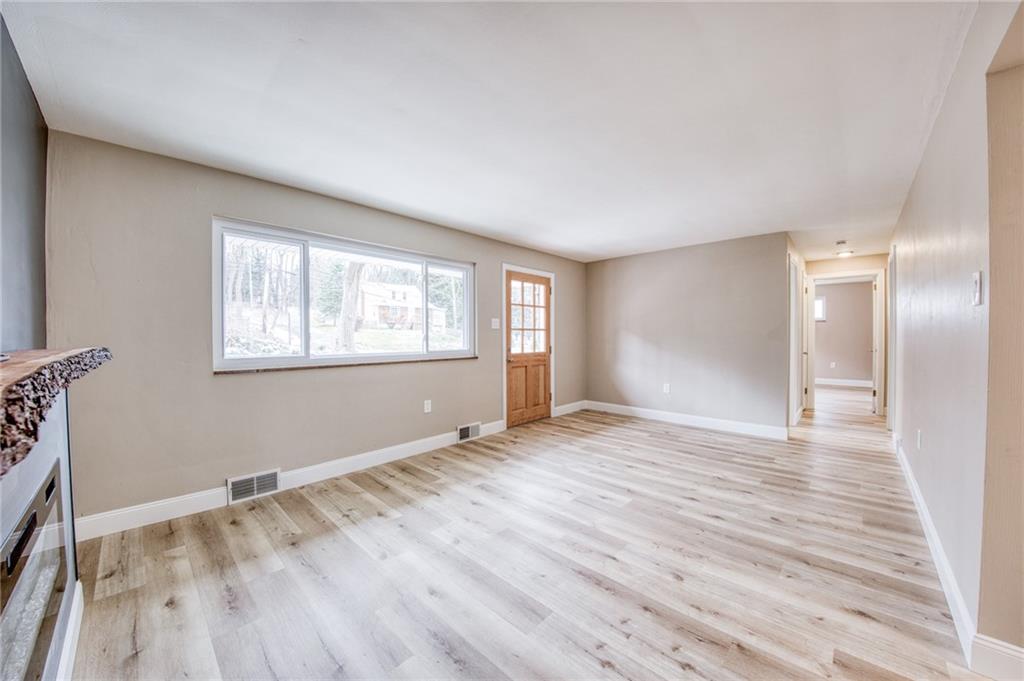 2158 Reis Run Road Pittsburgh, PA 15237 - Photo 10 of 50 a view of an empty room with wooden floor and a window