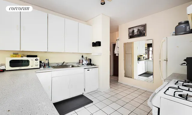 a kitchen with a sink cabinets and black stainless steel appliances