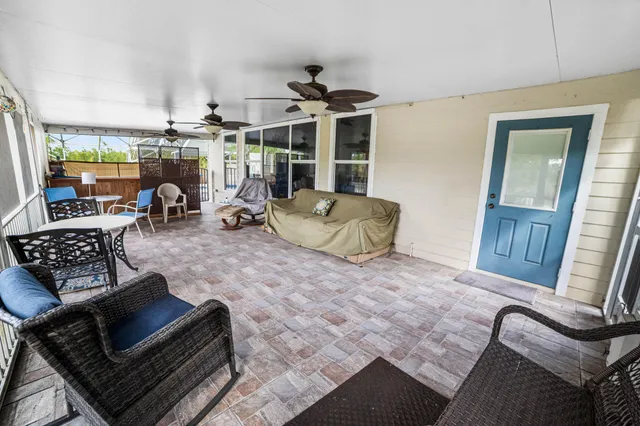 a bedroom with a large bed and a chandelier fan