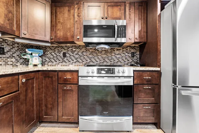 a view of a hallway with entryway and stairs