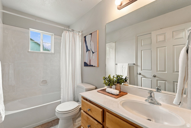 1041 South 1850th Street West Springville, UT 84663 - Photo 21 of 35 Bathroom featuring a windowed shower-tub combination with white surround, a vanity with wood-finish cabinetry, a single basin sink, and an expansive mirror