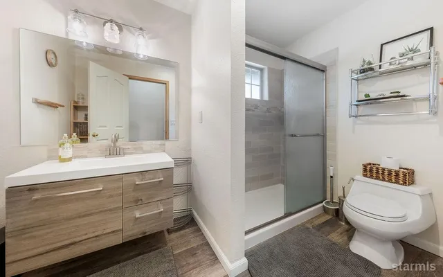 a bathroom with a toilet a sink and a mirror