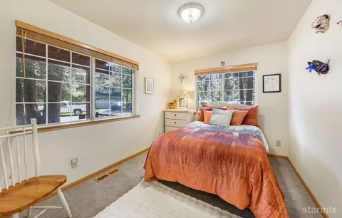 a bed room with a bed and a window