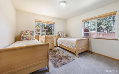 a bed sitting in a bedroom next to a window