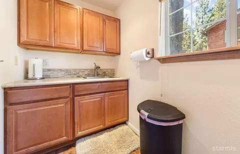 a bathroom with a granite countertop sink a toilet and a mirror