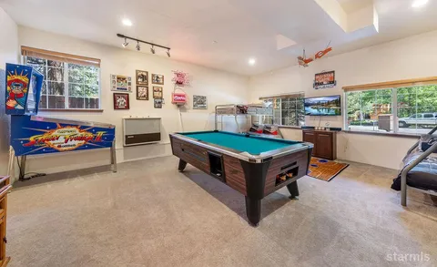 a room with furniture and pool table
