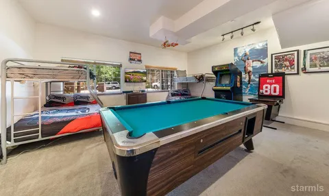 a room with pool table and flat screen tv