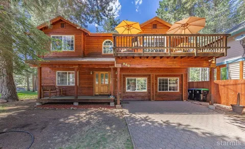 a backyard of a house with barbeque oven table and chairs