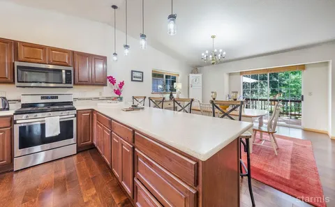 a kitchen with a stove a sink and a refrigerator
