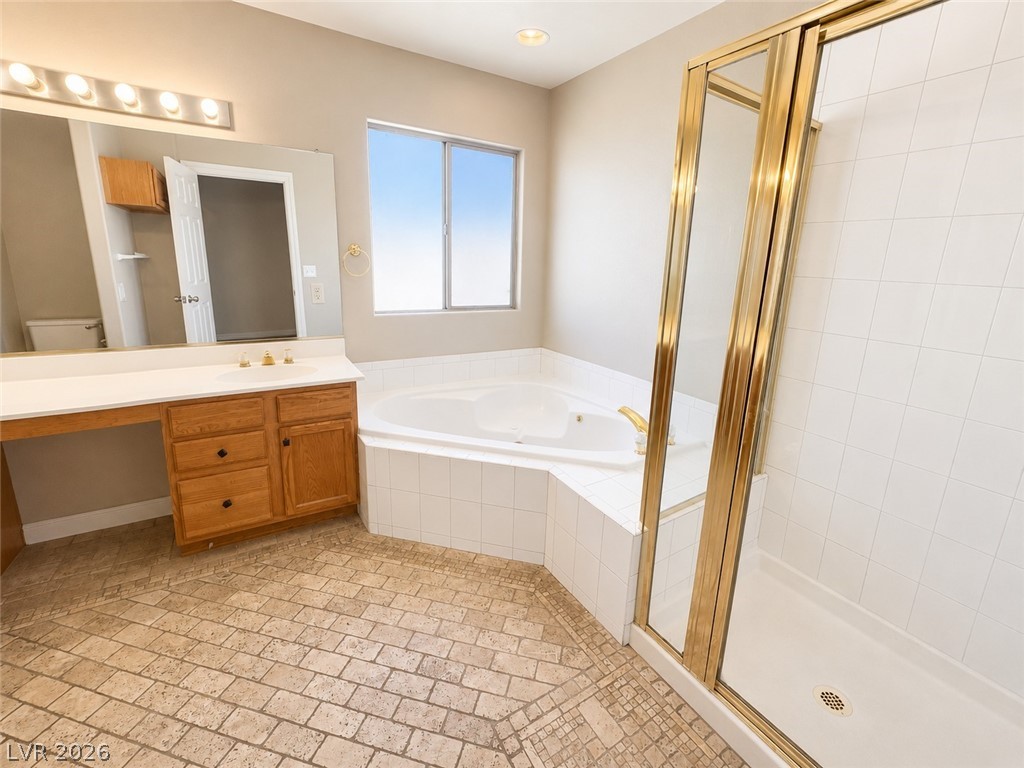7213 London Bridge Avenue Las Vegas, NV 89130 - Photo 8 of 11 This spacious bathroom offers a relaxing soaking tub and convenient shower, perfect for unwinding.