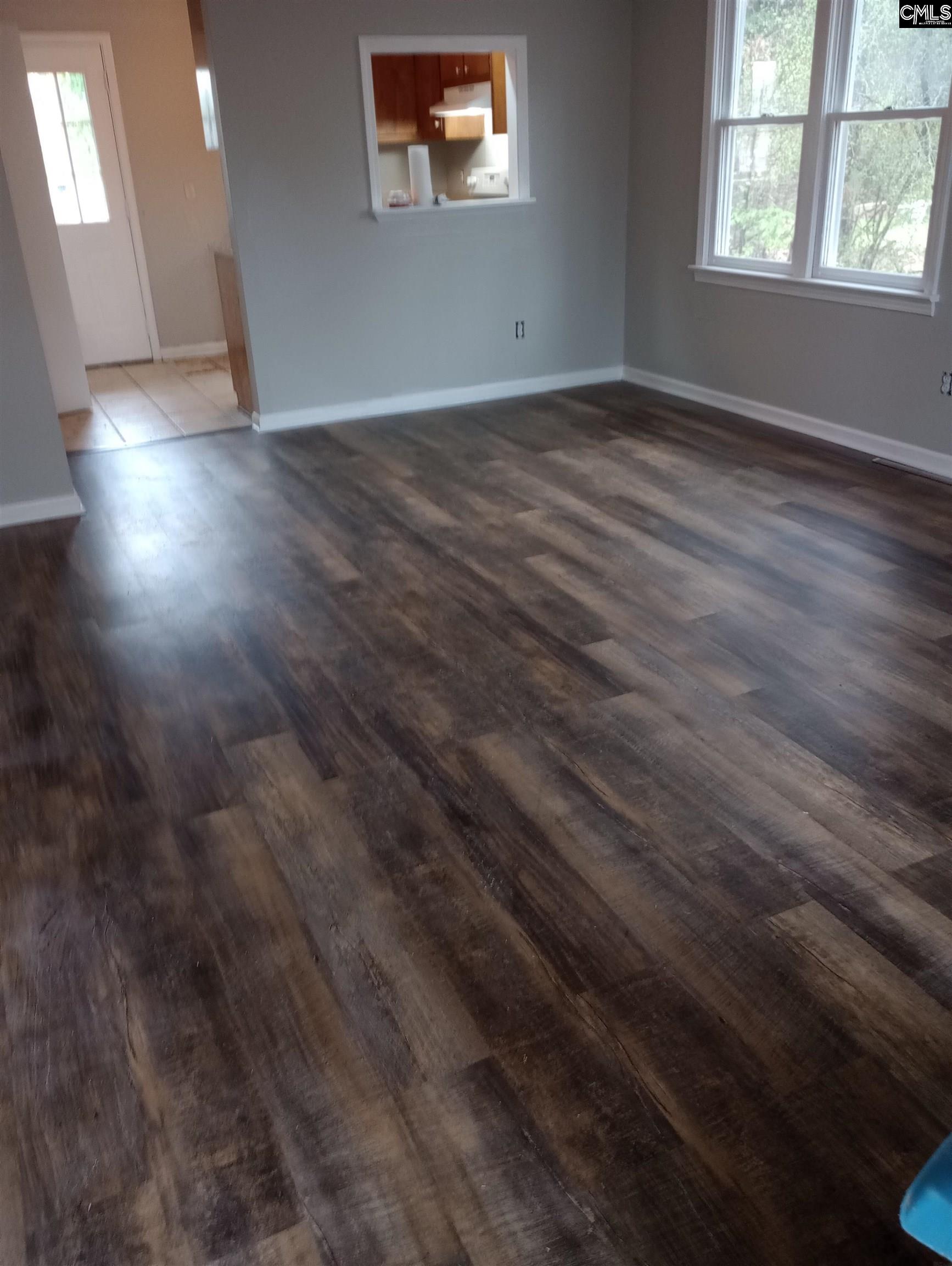 2444 Watson Street, Unit B Elgin, SC 29045 - Photo 2 of 5 an empty room with wooden floor and windows