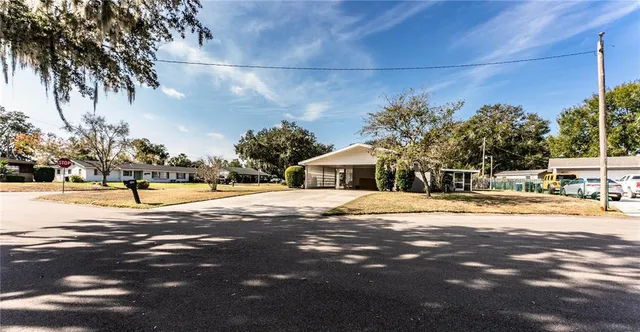 a view of a house with a yard and trees