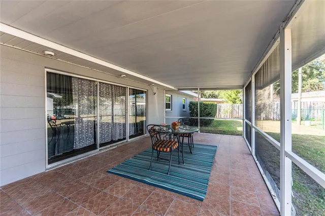 a dining room with furniture and a garden view