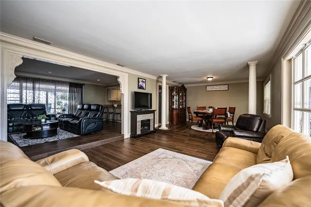 a living room with furniture fireplace and flat screen tv