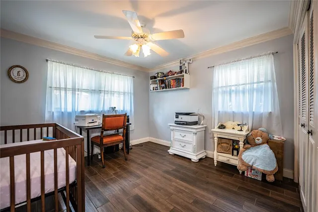 a view of a bedroom with furniture window and hardwood floor