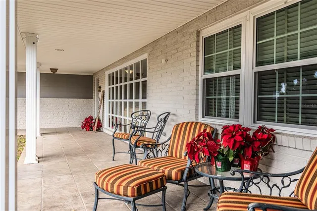 a balcony with furniture and flowers