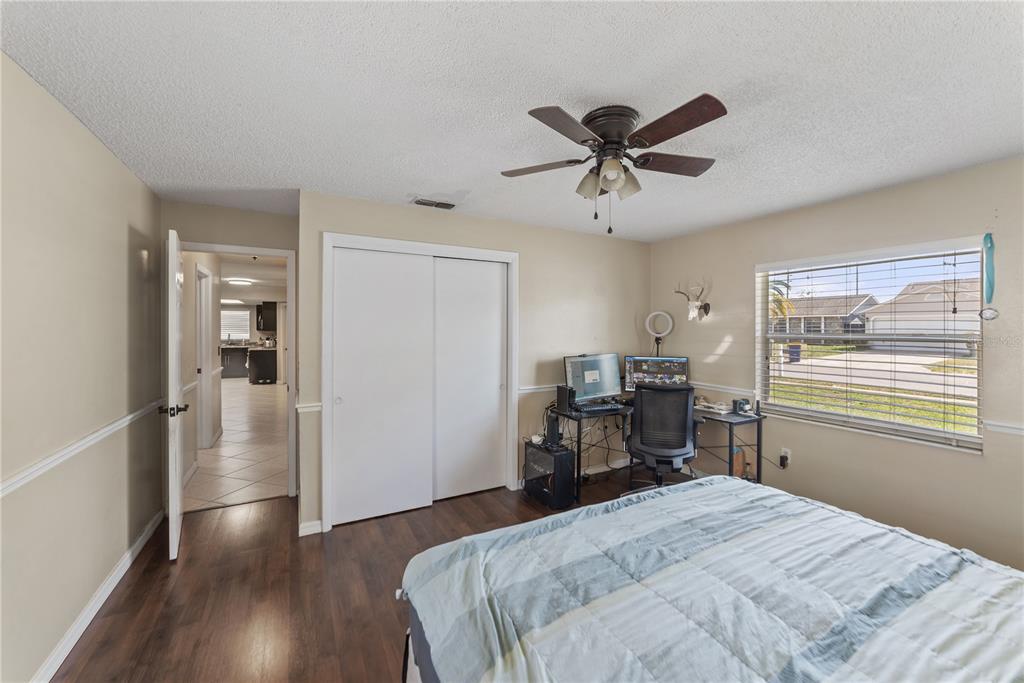 8715 Huntsman Lane Port Richey, FL 34668 - Photo 40 of 54 a bedroom with a bed and wooden floor