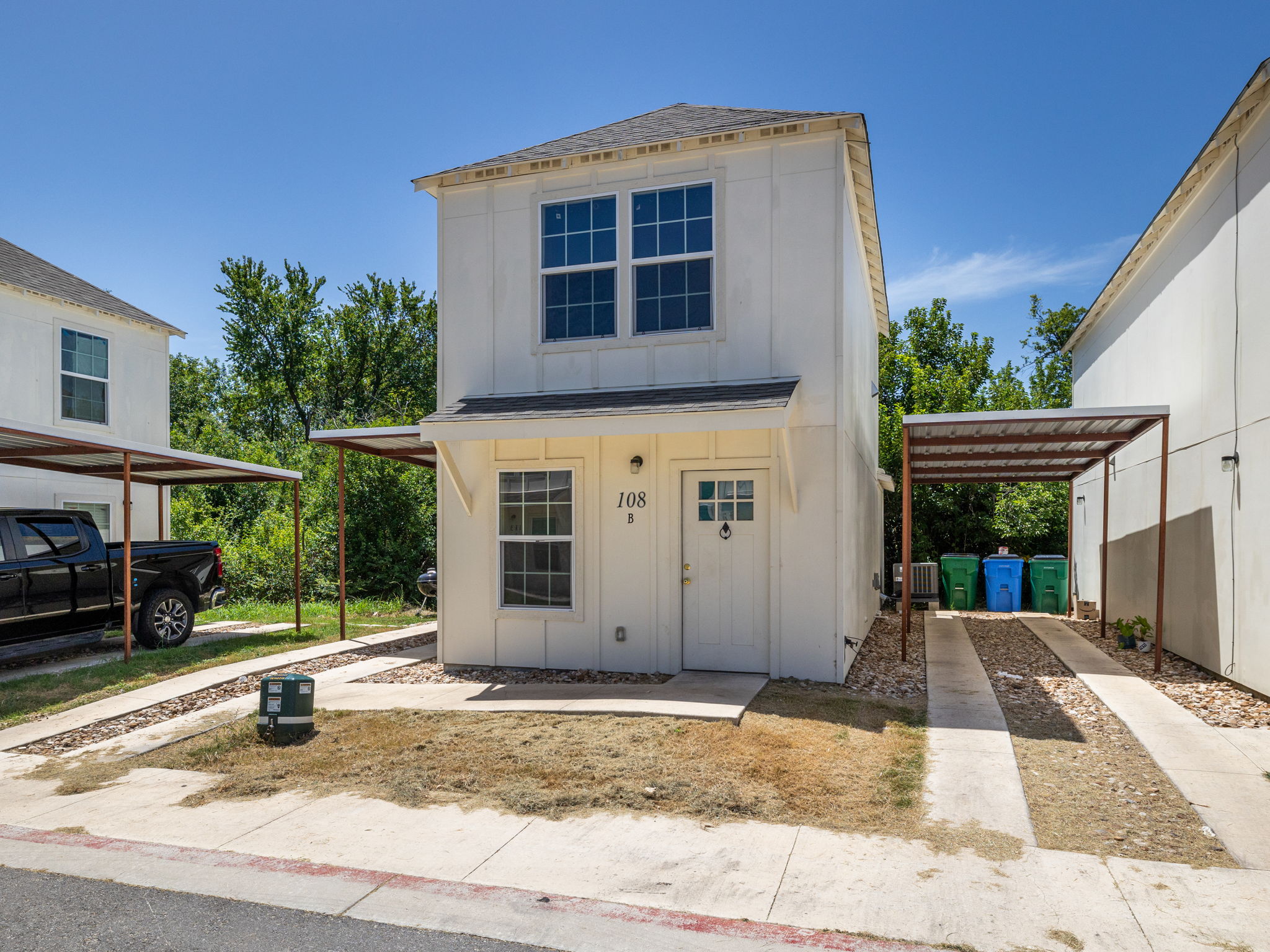 View of front facade featuring board and batten siding and a shingled roof