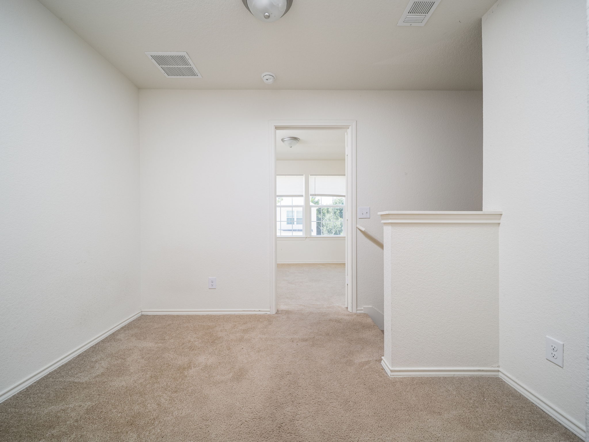 230 Debus Drive, Unit 108B Taylor, TX 76574 - Photo 13 of 16 Carpeted spare room featuring baseboards