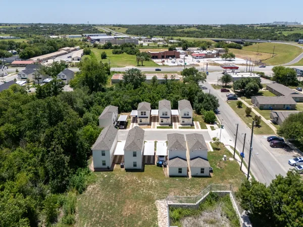 an aerial view of a house with a garden and lake view