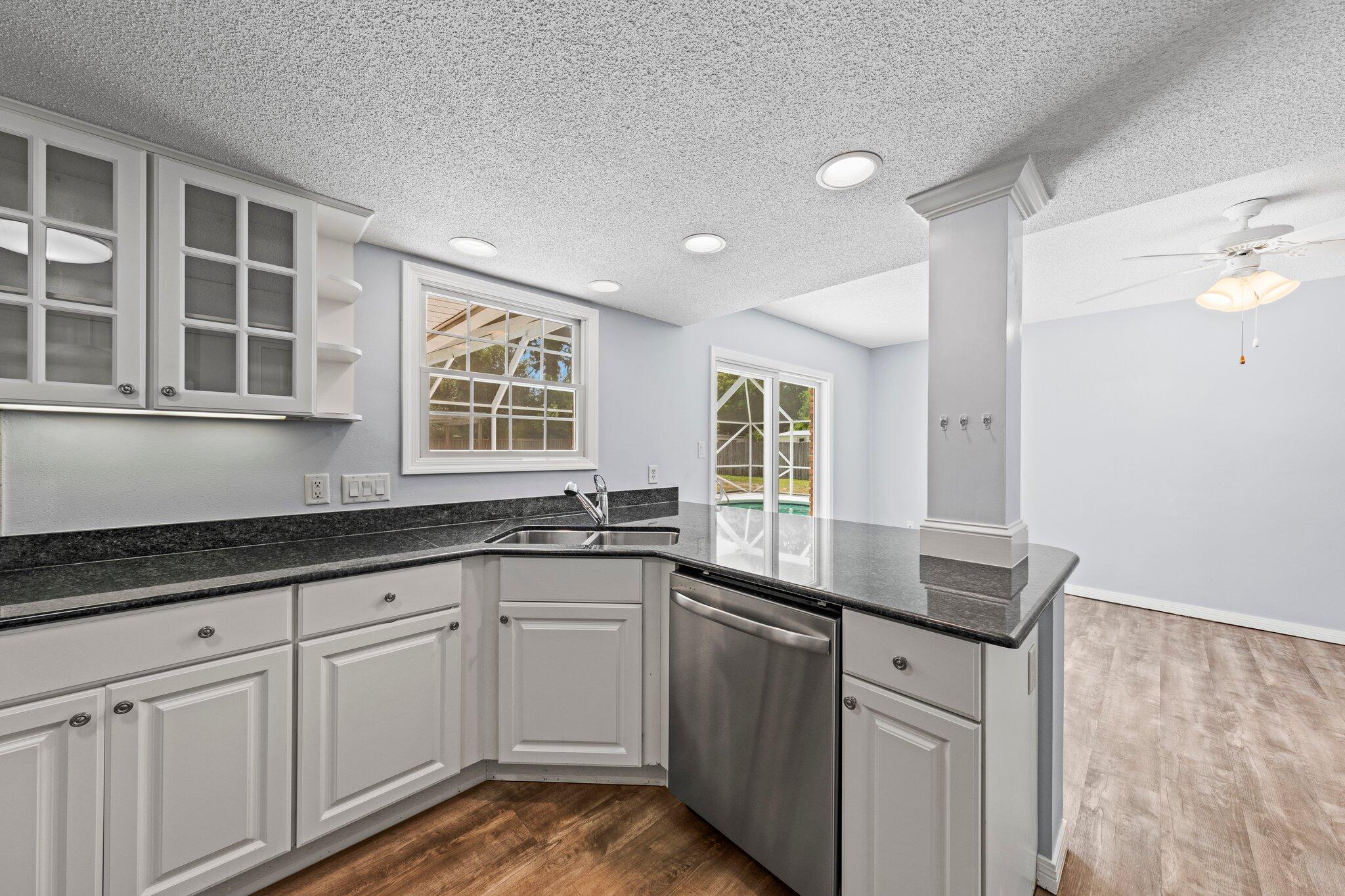 20 Maple Avenue Shalimar, FL 32579 - Photo 11 of 55 a kitchen with granite countertop white cabinets and sink