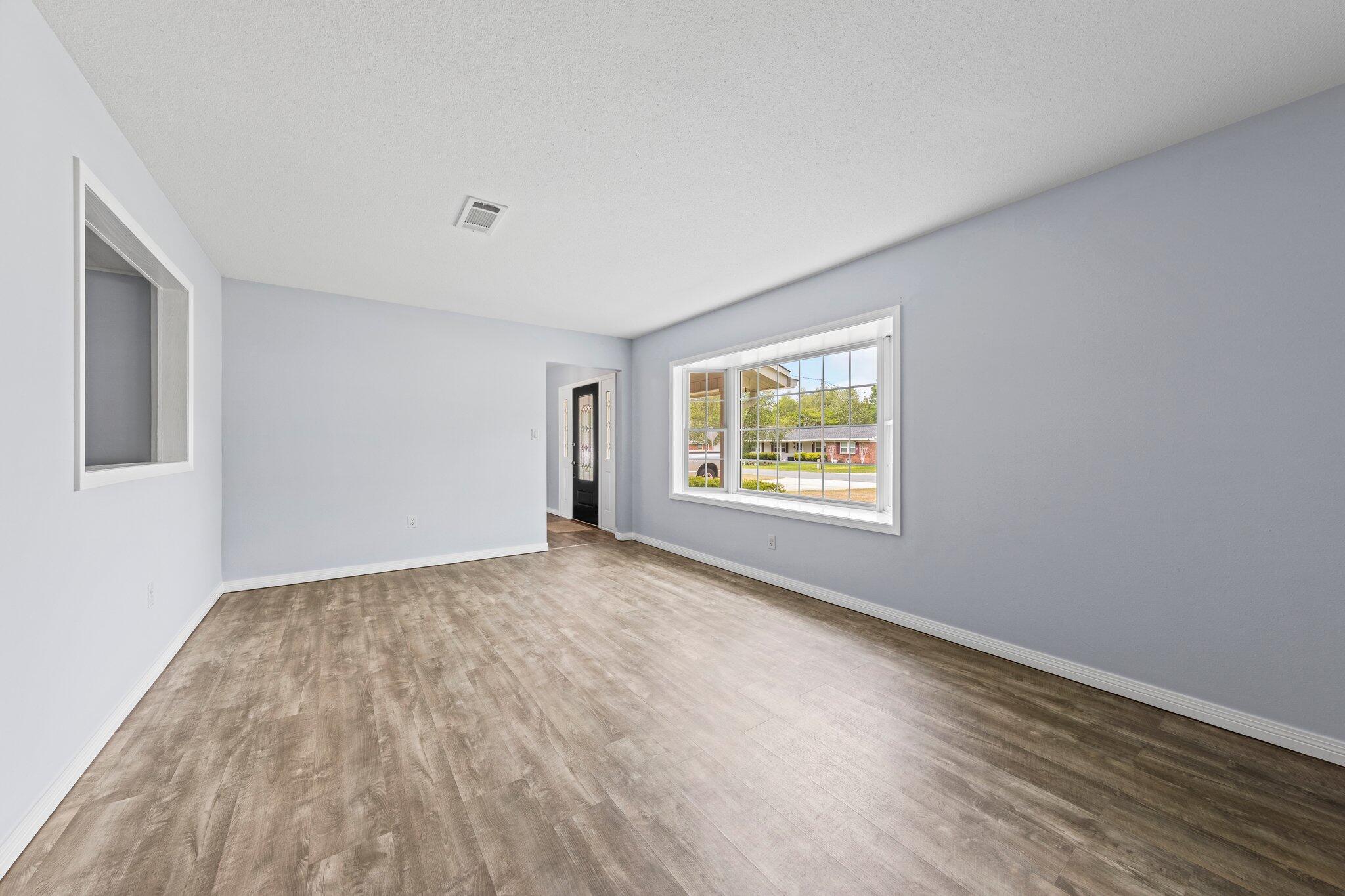 20 Maple Avenue Shalimar, FL 32579 - Photo 13 of 55 an empty room with wooden floor and windows