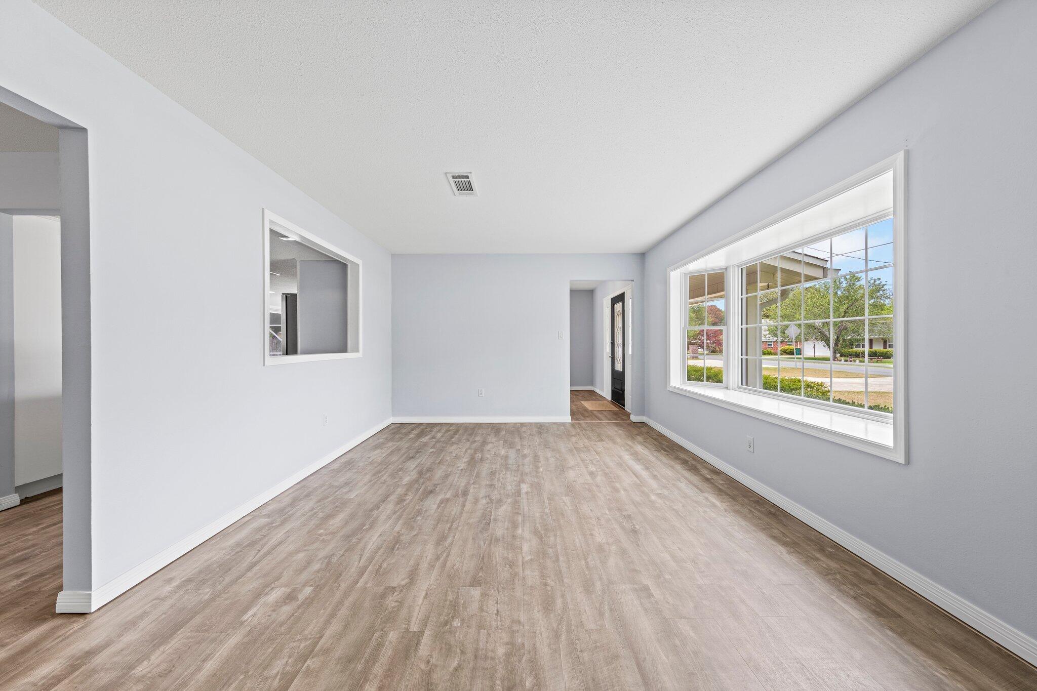 20 Maple Avenue Shalimar, FL 32579 - Photo 14 of 55 an empty room with wooden floor and windows
