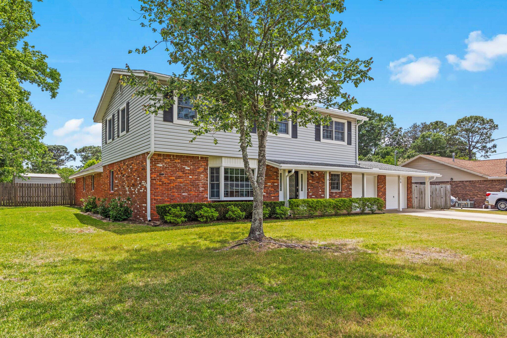 20 Maple Avenue Shalimar, FL 32579 - Photo 2 of 55 a front view of a house with a yard