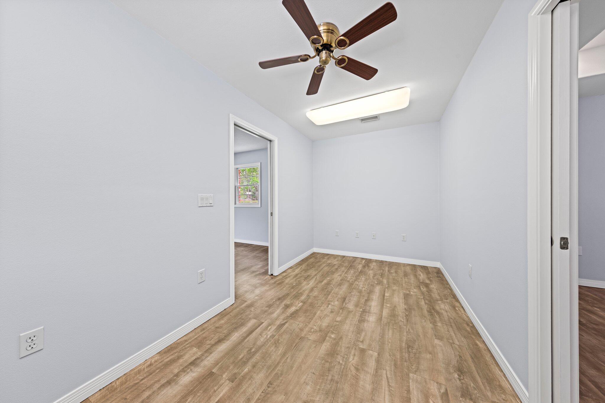 20 Maple Avenue Shalimar, FL 32579 - Photo 25 of 55 an empty room with a window and a ceiling fan