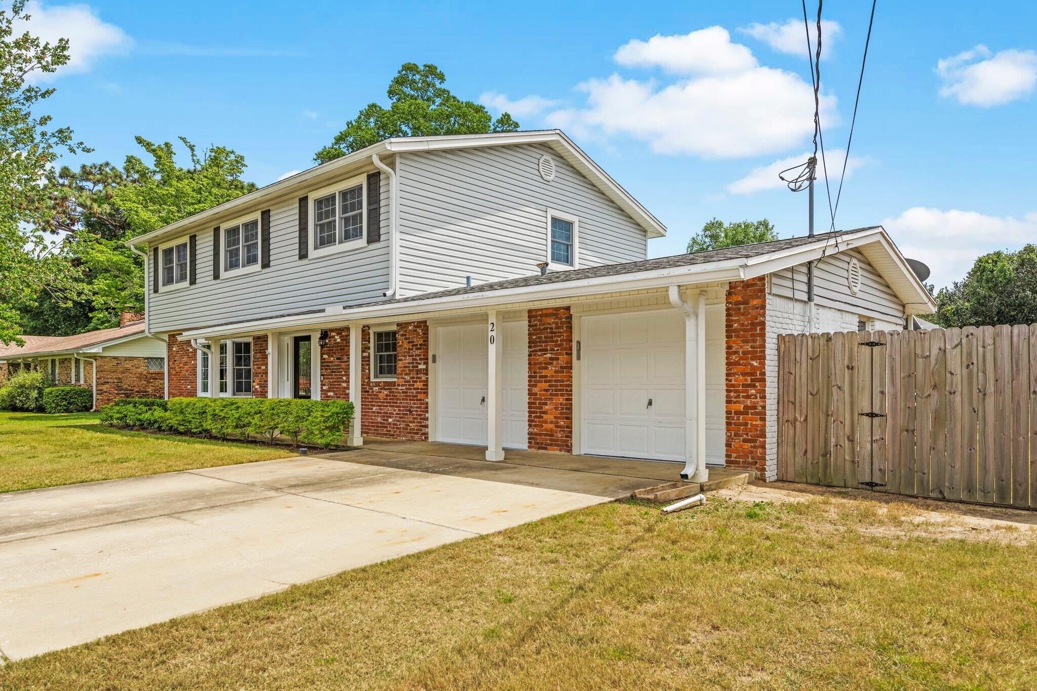 20 Maple Avenue Shalimar, FL 32579 - Photo 3 of 55 a front view of a house with a garden