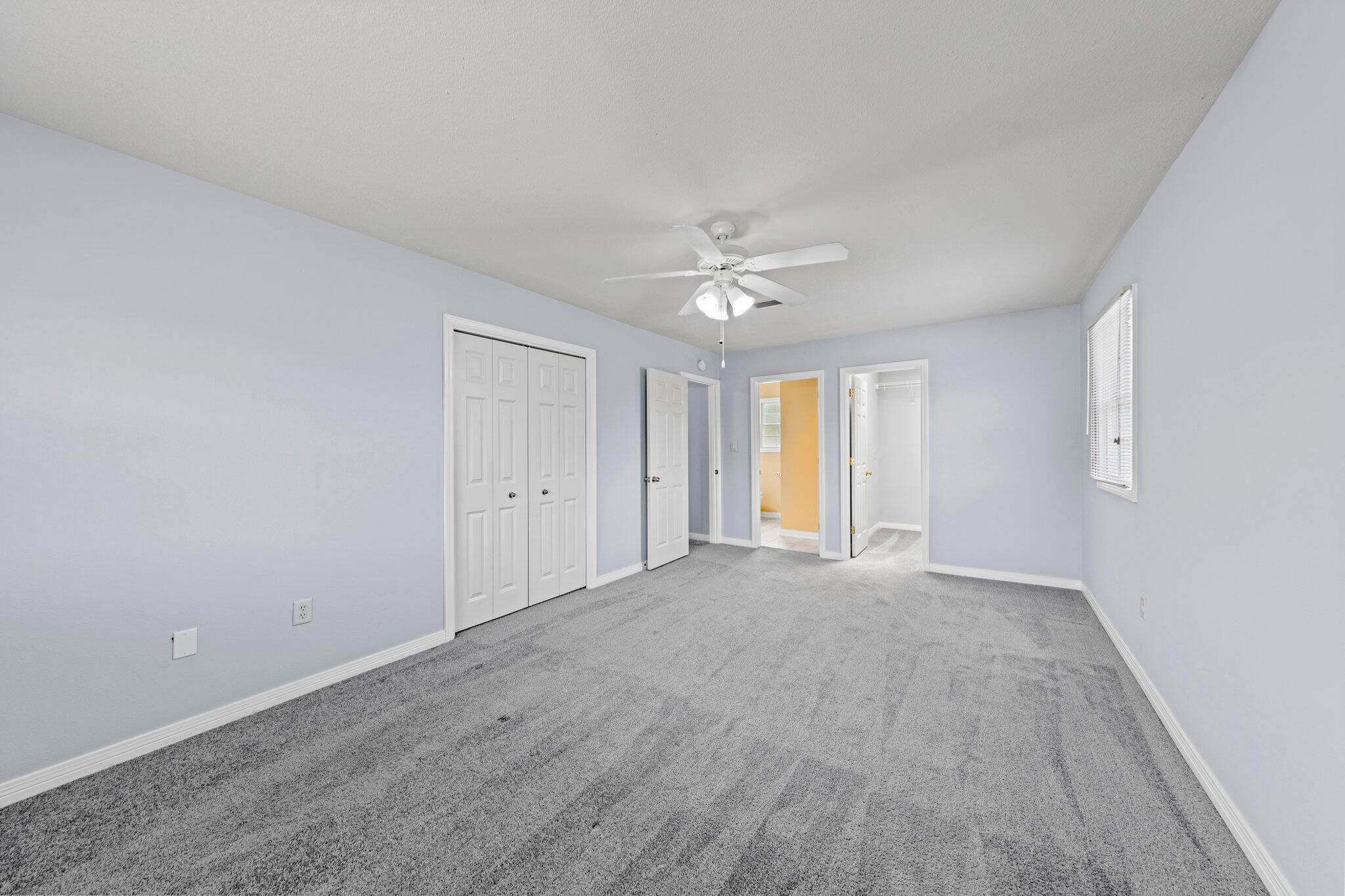 20 Maple Avenue Shalimar, FL 32579 - Photo 33 of 55 a view of an empty room with chandelier fan and windows