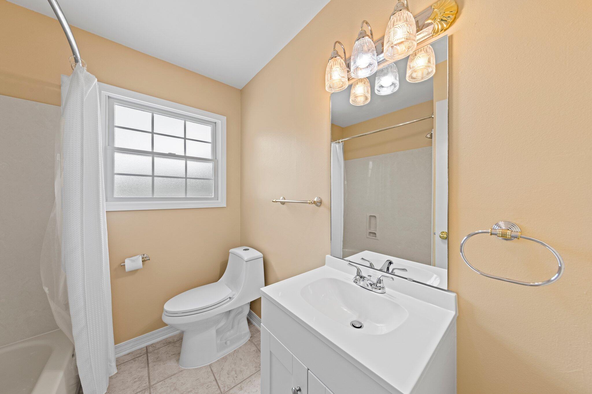 20 Maple Avenue Shalimar, FL 32579 - Photo 37 of 55 a bathroom with a sink a toilet and mirror