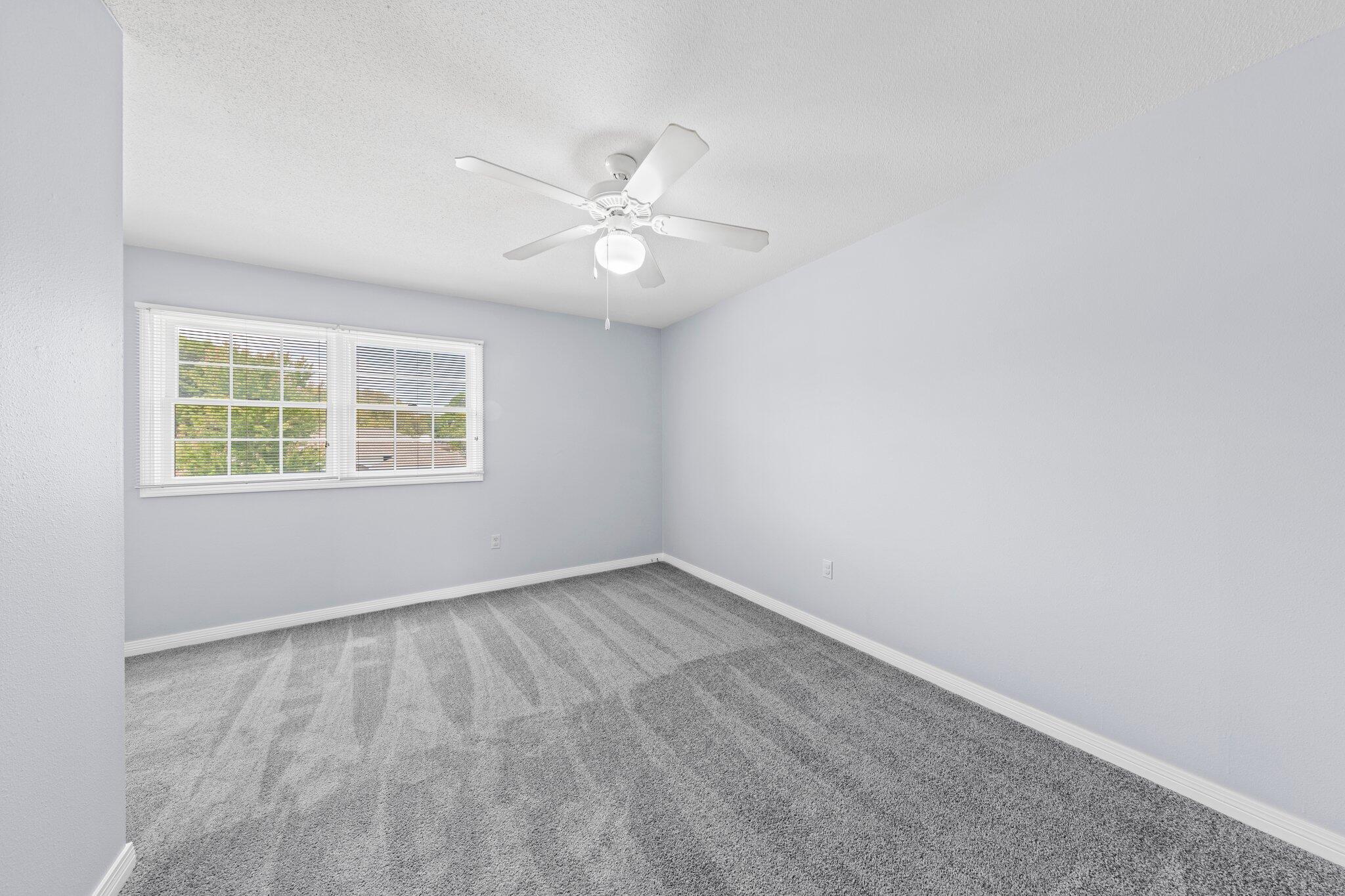20 Maple Avenue Shalimar, FL 32579 - Photo 38 of 55 an empty room with windows and ceiling fan