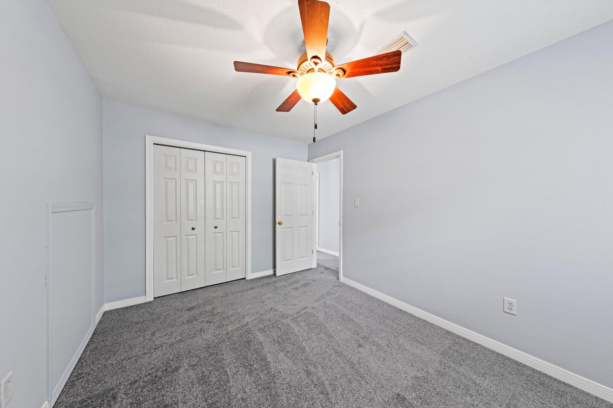 20 Maple Avenue Shalimar, FL 32579 - Photo 43 of 55 a view of an empty room and chandelier fan