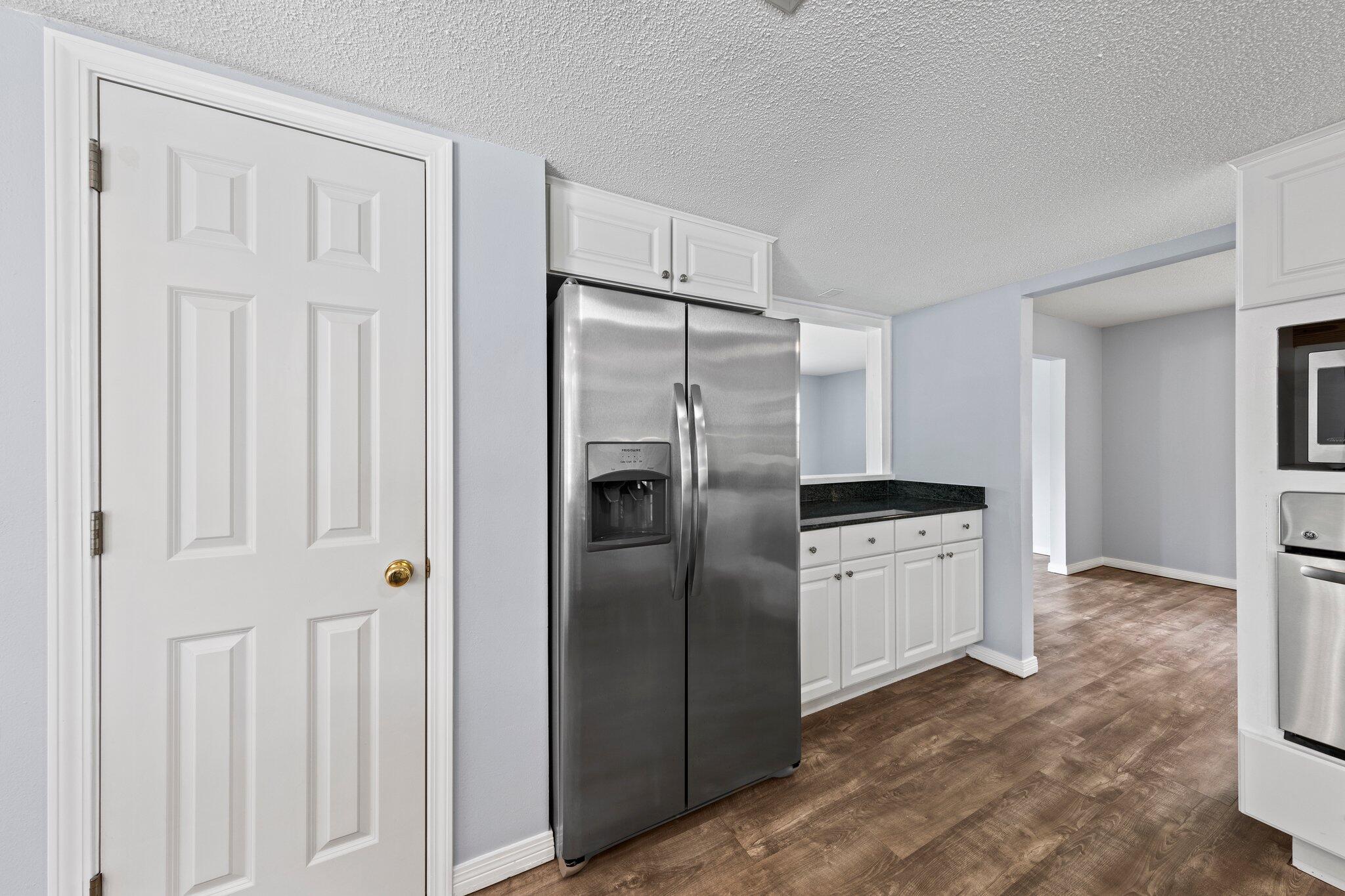 20 Maple Avenue Shalimar, FL 32579 - Photo 9 of 55 a kitchen with stainless steel appliances granite countertop a refrigerator and a sink