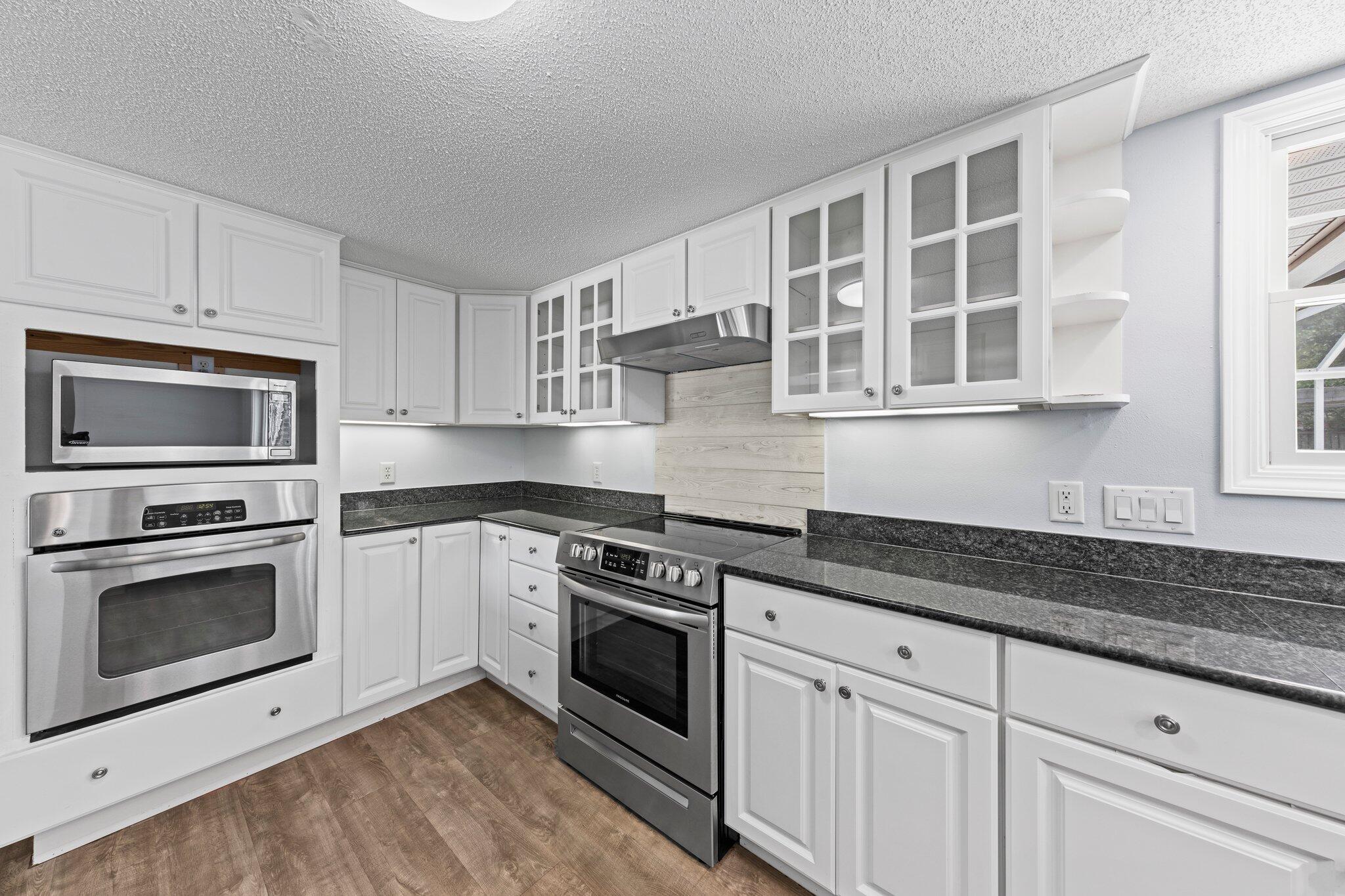 20 Maple Avenue Shalimar, FL 32579 - Photo 10 of 55 a kitchen with cabinets stainless steel appliances and a sink