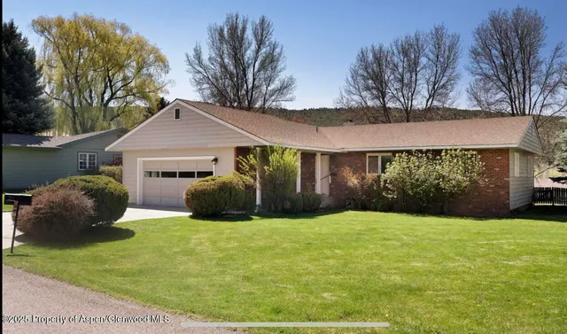 a view of a house with backyard and garden