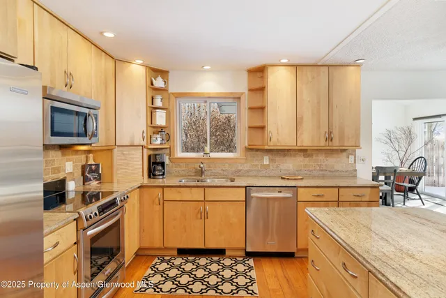 a kitchen with a sink stove and wooden cabinets